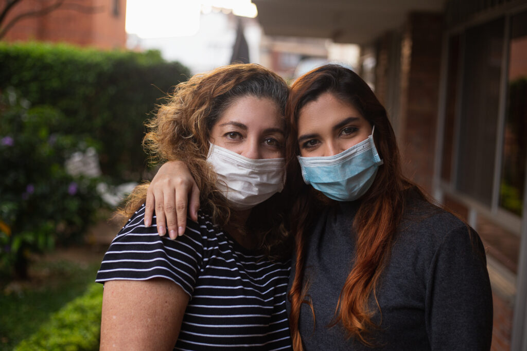 mother and daughter wearing masks